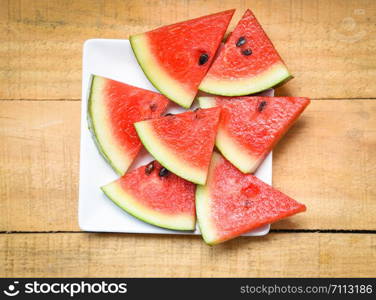 Watermelon slice on white plate summer fruit on the wooden background