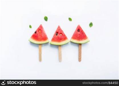 Watermelon slice popsicles on white background