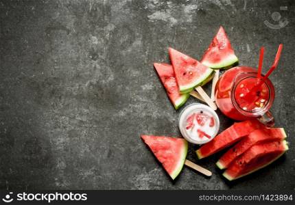 Watermelon smoothies and juice with pulp. On the stone table.. Watermelon smoothies and juice with pulp.