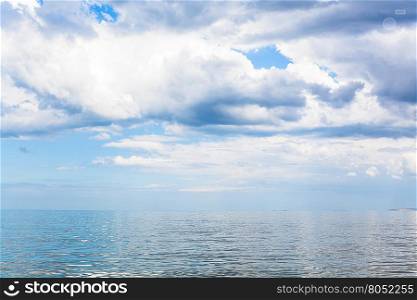 waterscape with white clouds and calm water of Sea of Azov, Temryuk bay, Golubitskaya resort, Taman peninsula, Kuban, Russia