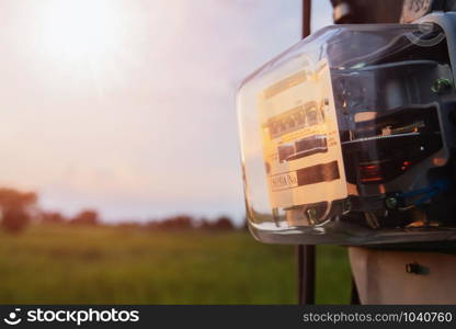 watthour meter amp of electricity of use at home sunset background