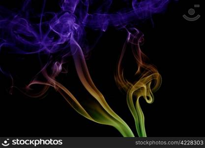 wave and smoke of different colors on black background