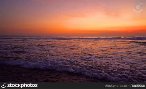 Wave at Bali beach, Indian ocean at sunset in Indonesia. Nature sea. Landscape sky background.