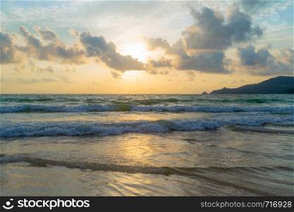 Wave at Phuket beach, Andaman Sea at sunset in Thailand. Nature sky background.