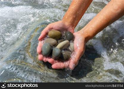 Wave covered palms with large sea pebbles