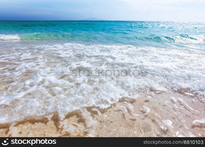 Wave of sea on sand beach beautiful natural background , seaside vacation concept. Wave of sea on sand beach