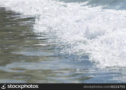 Wave on seashore . Wave on seashore close up with white foam on sunny day