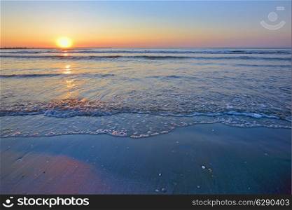 waves and sunrise on Black Sea beach