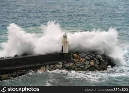Waves break on the lighthouse