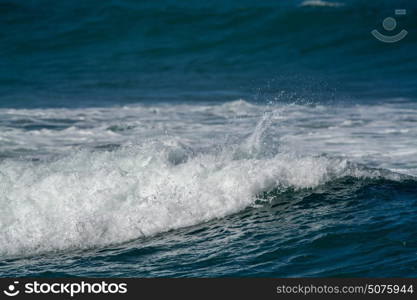 waves breaking into the shore in the late afternoon