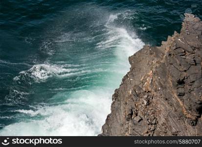 Waves breaking on rocky coast. View from above.