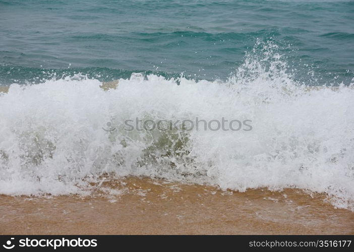 Waves breaking on shore of the sea