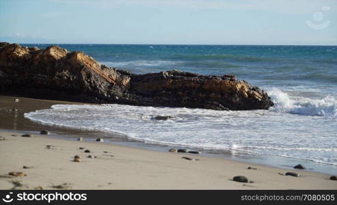 Waves crash along a rocky beach near Point Conception State Marine Reserve