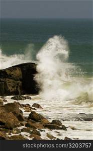 Waves crashing against a rock formation in the sea