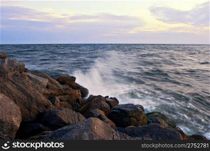 Waves crashing on ocean rocks