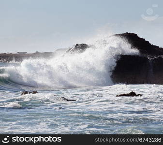 Waves crashing on rocks in Kauai