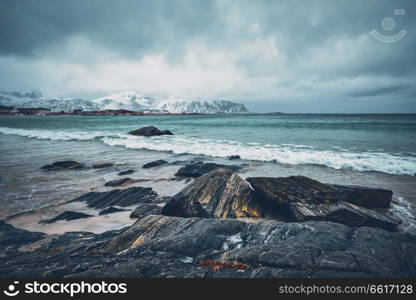Waves of Norwegian sea on rocky beach of fjord. Ramberg beach, Lofoten islands, Norway. Lofoten islands landscape