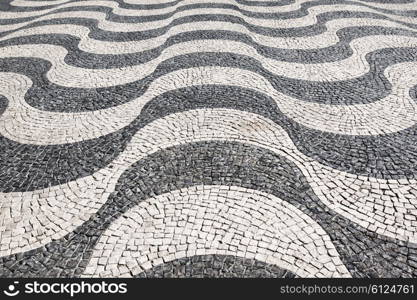 Waves of tiled floor in portuguese traditional style, Rossio square, Lisbon