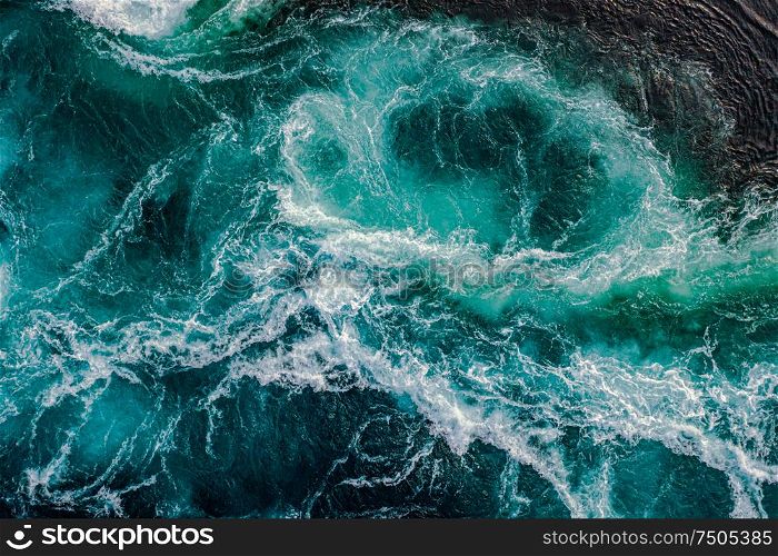 Waves of water of the river and the sea meet each other during high tide and low tide. Whirlpools of the maelstrom of Saltstraumen, Nordland, Norway