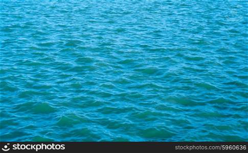 Waves on blue water background