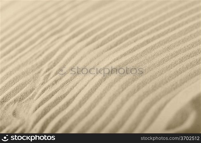 Waves on light sea sand close up