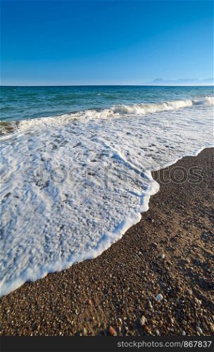 Waves on shore on sunny day in Antalya Turkey. Waves on shore