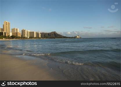 Waves on the beach with buildings in the background, Waikiki, Honolulu, Oahu, Hawaii, USA