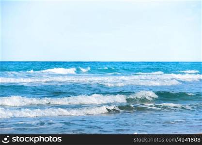 Waves on the blue sea water at a beach