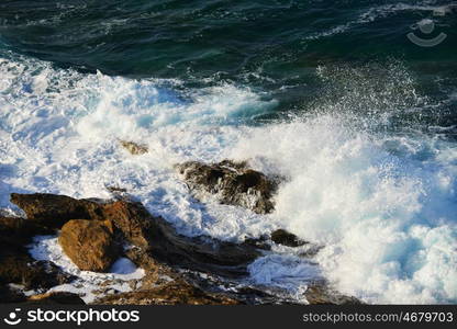 waves splash at stones on shore sea