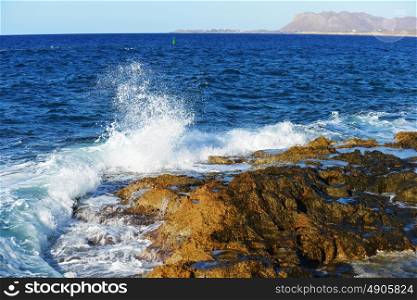waves splash at stones on shore sea