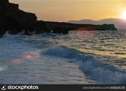 waves splash at stones on shore sea
