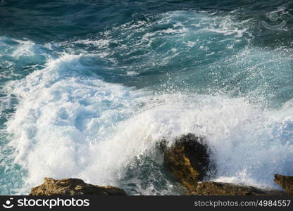 waves splash at stones on shore sea