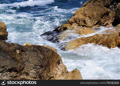 Waves splashing into rocks at sea