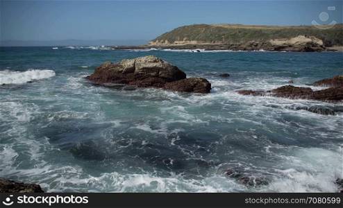 Waves wash over shallow rocks near Spoonera??s Cov