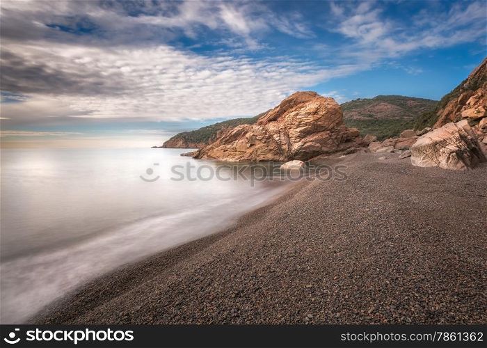 Waves washing onto pebbles at Bussagli beach near Porto in western Corsica