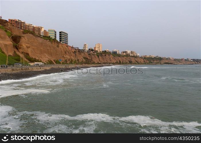 Waves with a city in the background, Miraflores District, Lima Province, Peru