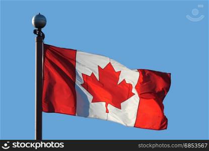 Waving Canadian flag against blue sky for celebrating Canada 150 years