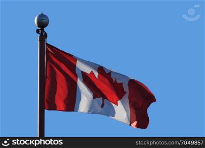 Waving Canadian flag against blue sky for celebrating Canada 150 years