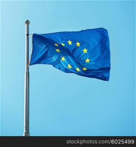 Waving Europian Union EU flag on the blue sky background
