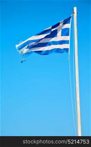 waving greece flag in the blue sky and flagpole