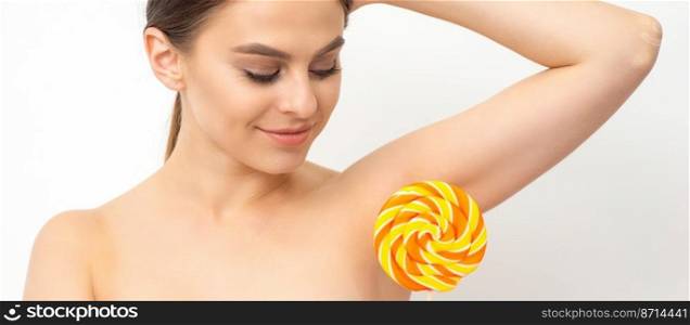Waxing, depilation concept. The beautiful young caucasian woman covers her armpit with a lollipop on white background. Waxing, depilation concept. The beautiful young caucasian woman covers her armpit with a lollipop on white background.