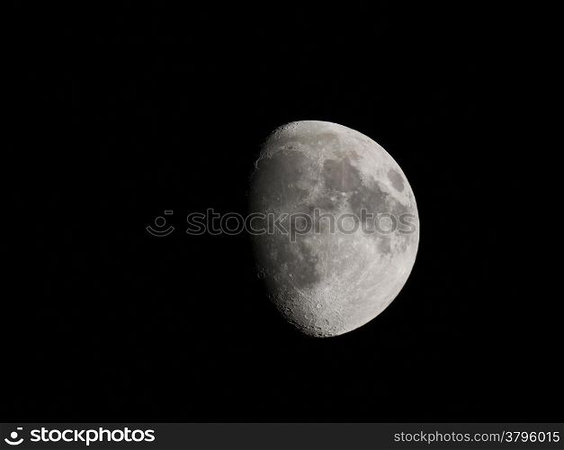 Waxing gibbous moon over dark sky at night