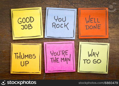 way to go, good job, well done, you&rsquo;re the man, thumbs up, you rock - a set of colorful sticky notes with positive affirmation words against rustic wood