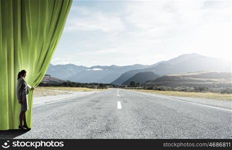 Way to something new. Businesswoman opening curtain to new roads and opportunities