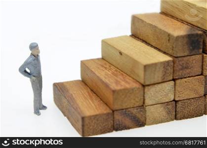 Way to success with mini businessman and wood block step