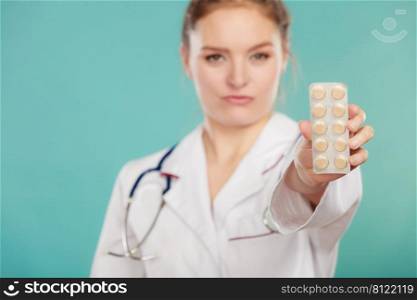Ways of treatment. Pharmacist doctor in white medical unform apron showing pills. Woman specialist with stethoscope holding medication.. Pharmacist with pills medication.