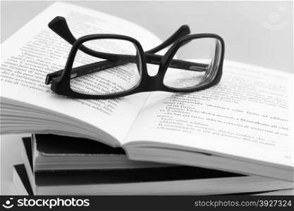 We are going to read books. Books and glasses on white background.