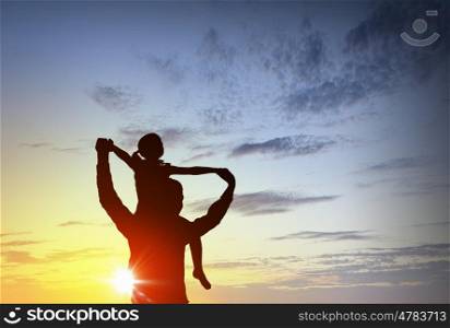 We are happy family. Father and little daughter silhouettes on sunset background