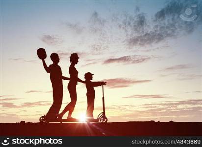 We are happy family. Silhouettes of happy family of three people mother father and child