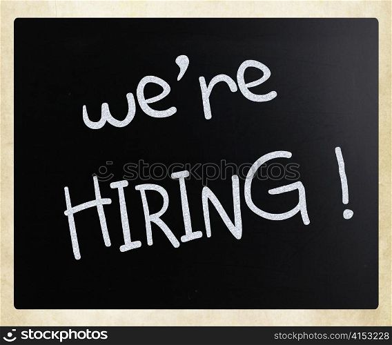 ""We are hiring!" handwritten with white chalk on a blackboard"